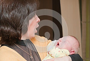 Grandma holds the newborn grandson