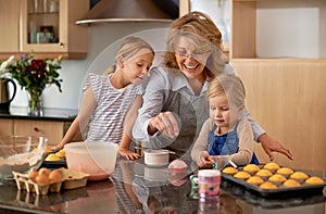 Grandma, kid and baking with teaching, smile and decorating for cheerful bonding together at home. Happy, pensioner or