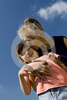 Grandma kissing her granddaughter