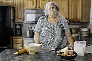 Grandma in a kitchen preparing to bake