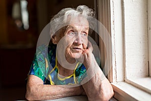 Grandma looks out the window.