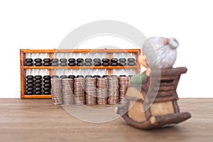 The grandma model faces a row of dollar coins and an abacus calculation tool