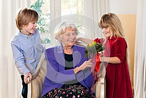 Grandma Receiving Flowers from Grandchildren.