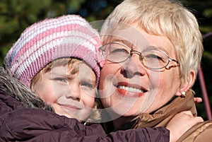 Grandmather and granddaughter in park