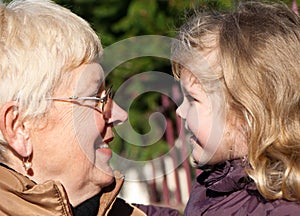 Grandmather and granddaughter in park