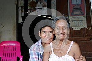 Grandmother and auntie are smiling at the front of the house. photo