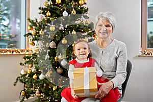 grandmother and baby girl with christmas gift