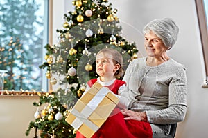 grandmother and baby girl with christmas gift