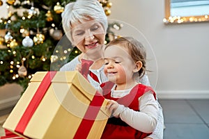 grandmother and baby girl with christmas gift