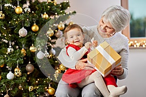 grandmother and baby girl with christmas gift