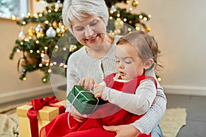 grandmother and baby girl with christmas gift