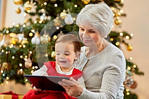 grandmother and baby girl with christmas gifts