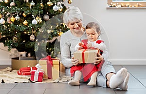 grandmother and baby girl with christmas gifts