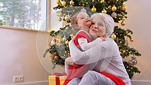 grandmother and baby girl hugging on christmas