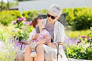 Grandmother and baby granddaughter with phone