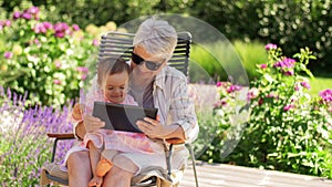 Grandmother and baby granddaughter with tablet pc