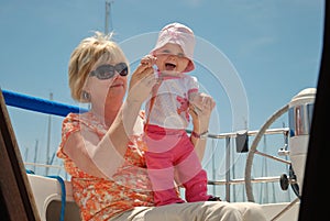 Grandmother and baby on a sailboat