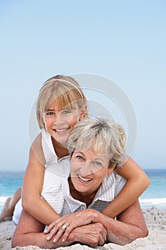 Grandmother On Beach With Granddaughter