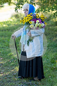 Grandmother with a cane and flowers