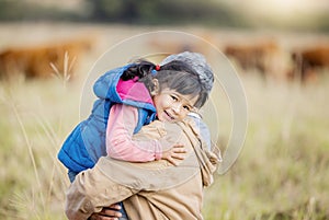 Grandmother carrying girl, field portrait and family farm, grass and bonding together with love outdoor. Old woman