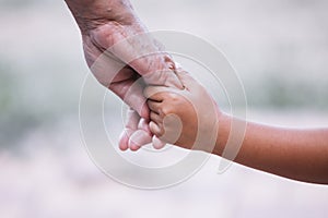 Grandmother and child little girl holding hand together