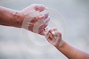 Grandmother and child little girl making a pinkie promise