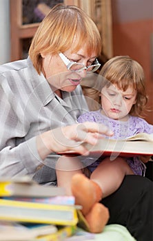 Grandmother and child reads book