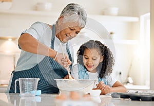 Grandmother, cooking or child baking in kitchen as a happy family with young girl learning cookies recipe. Mixing cake