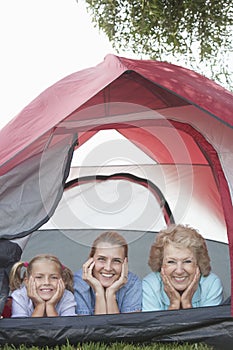 Grandmother, Daughter And Granddaughter Smiling From Tent