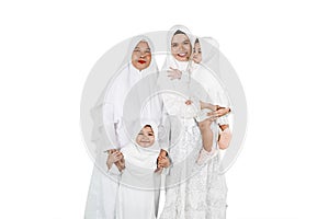 Grandmother with daughter and granddaughters isolated over white background