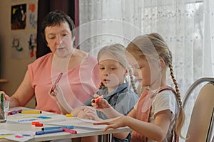 grandmother draws with granddaughters home