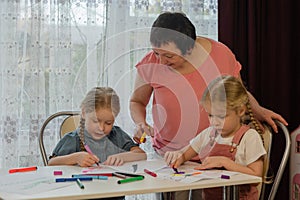 grandmother draws with granddaughters home