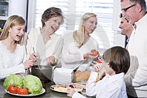 Grandmother with family laughing in kitchen