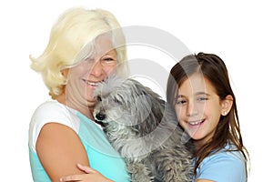 Grandmother and girl hugging the family dog