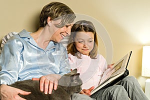 Grandmother and girl looking at photo album