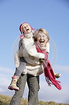 Grandmother Giving Her Granddaughter Piggy Back