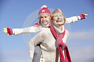 Grandmother Giving Her Granddaughter Piggy Back