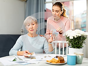 Grandmother giving money to granddaughter