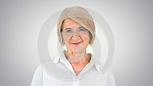 Grandmother in glasses and with gray hair happy and smiling look