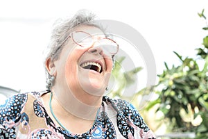 Grandmother with glasses and gray hair very happy smiling with denture