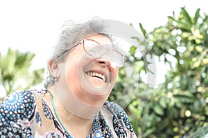 Grandmother with glasses and gray hair very happy smiling with denture