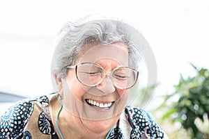 Grandmother with glasses and gray hair very happy smiling with denture