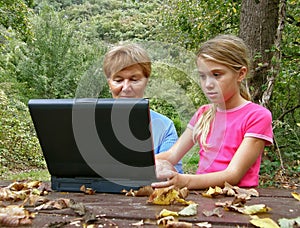 Grandmother and grandaughter with laptop