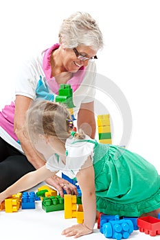 Grandmother with grandchildren playing with blocks