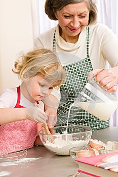 Grandmother and granddaughter baking cookies photo