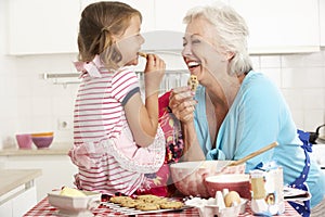 Grandmother And Granddaughter Baking In Kitchen photo