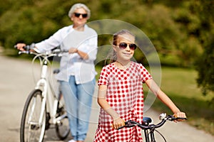 Grandmother and granddaughter with bicycles