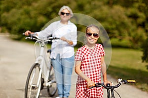 Grandmother and granddaughter with bicycles