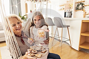 Grandmother and granddaughter celebrating Christmas at home