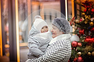 Grandmother and Granddaughter on the Christmas street